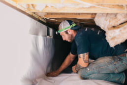 Worker under crawl space