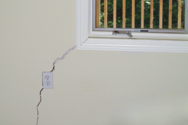 stucco crack in wall near window 